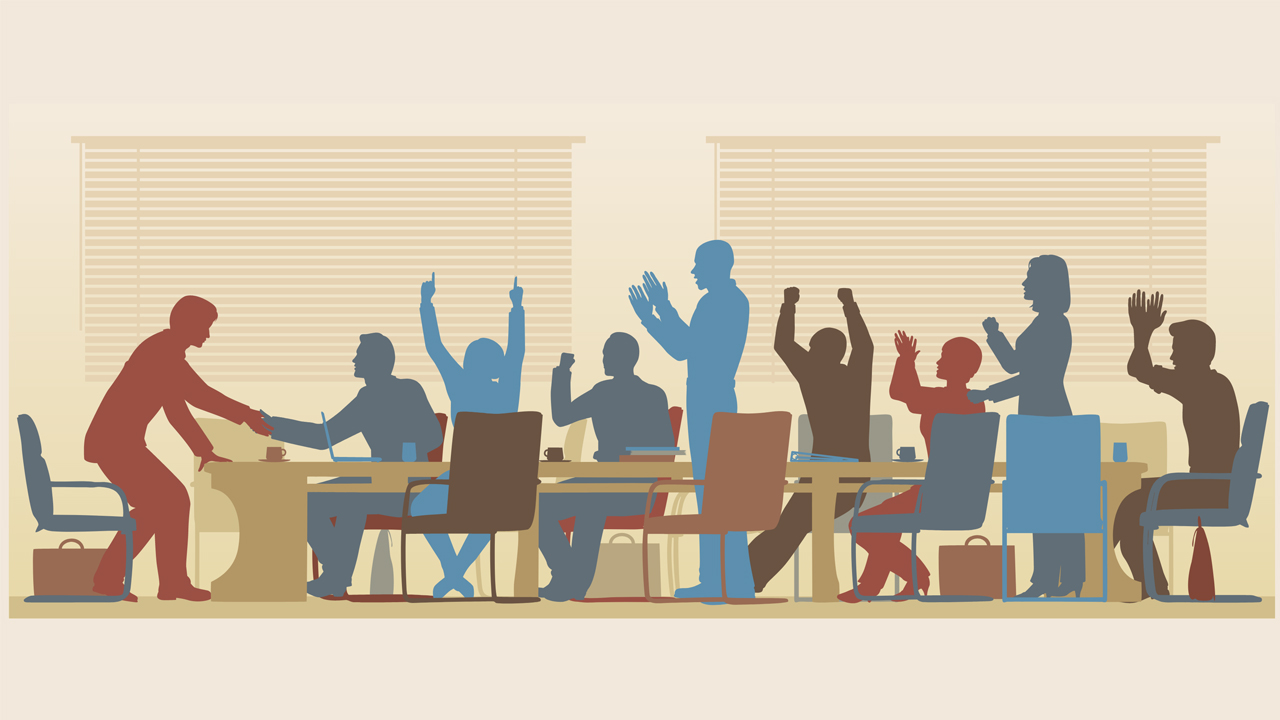 Silhouettes of employees celebrating around a long conference table.